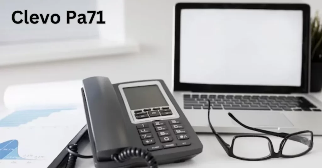 a telephone and laptop on a desk